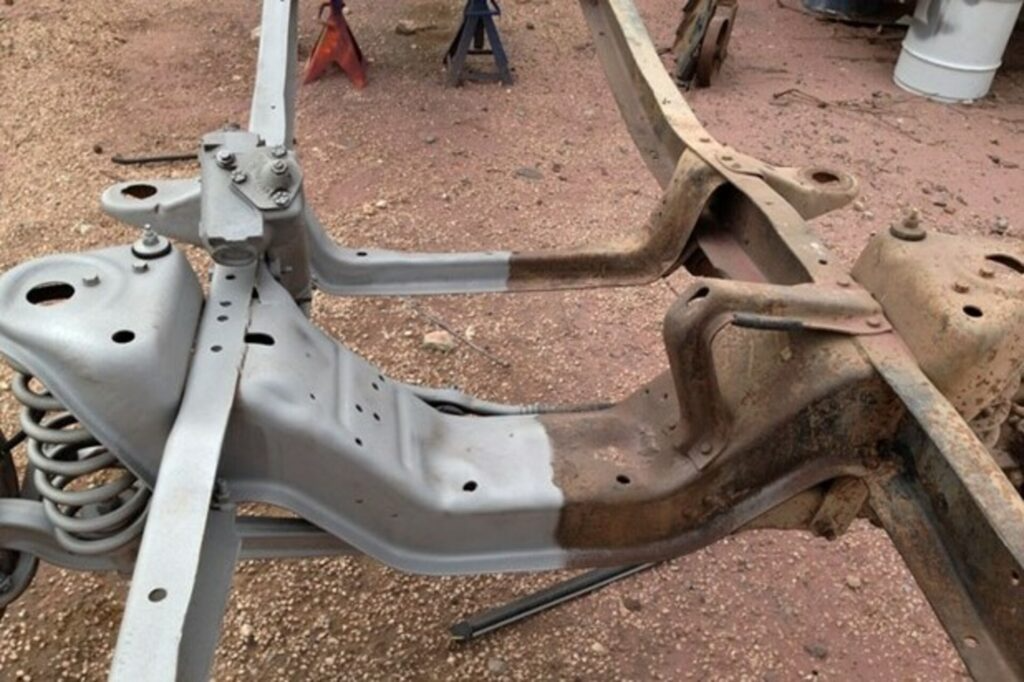Vehicle frame, half rusted and half blasted clean